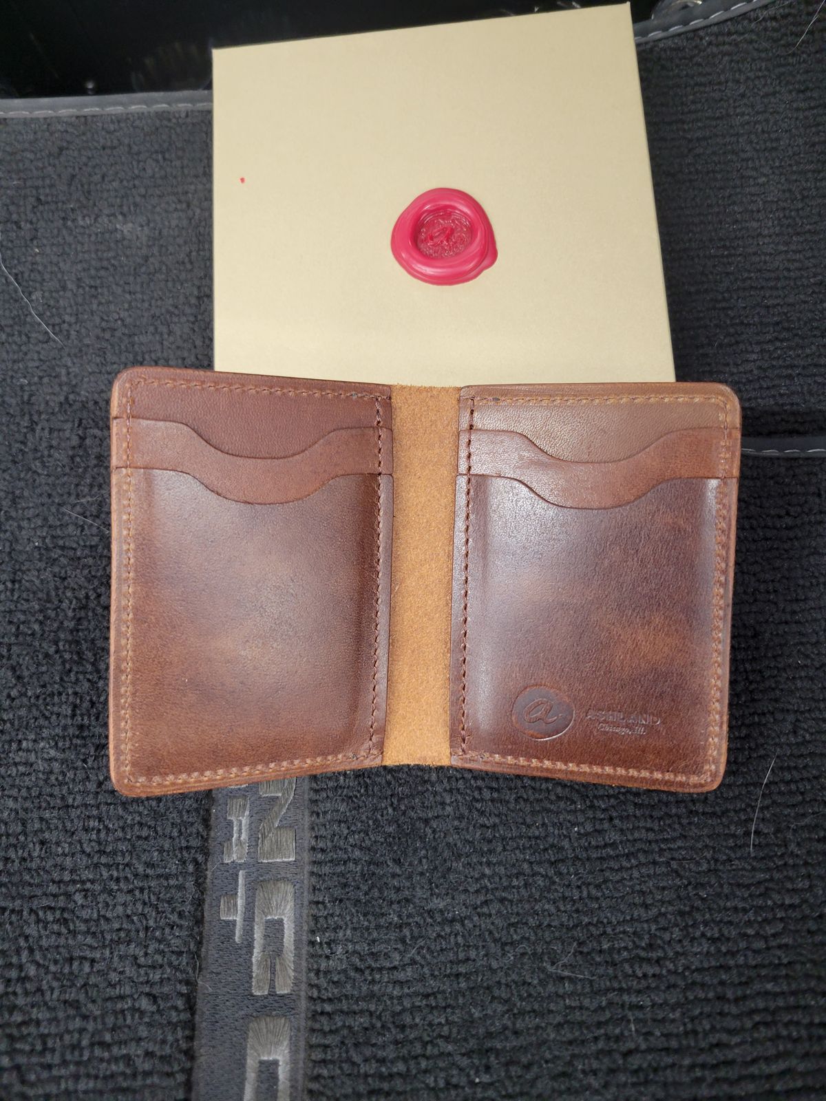 Photo by Cecilk on October 24, 2025 of the Ashland Leather Vertical Bugs Moran Wallet in Horween Brown Veg Tanned.