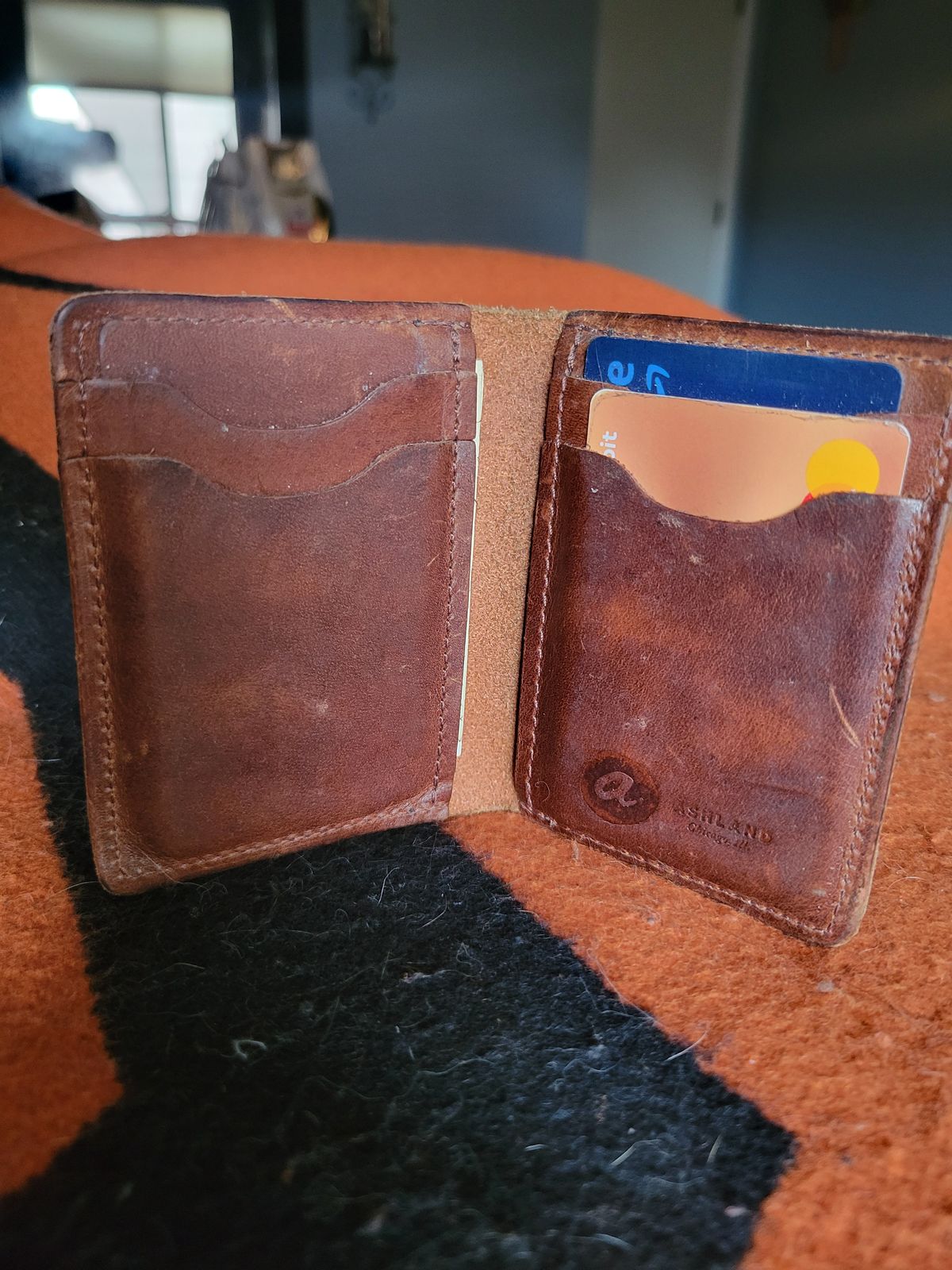 Photo by Cecilk on March 1, 2026 of the Ashland Leather Vertical Bugs Moran Wallet in Horween Brown Veg Tanned.