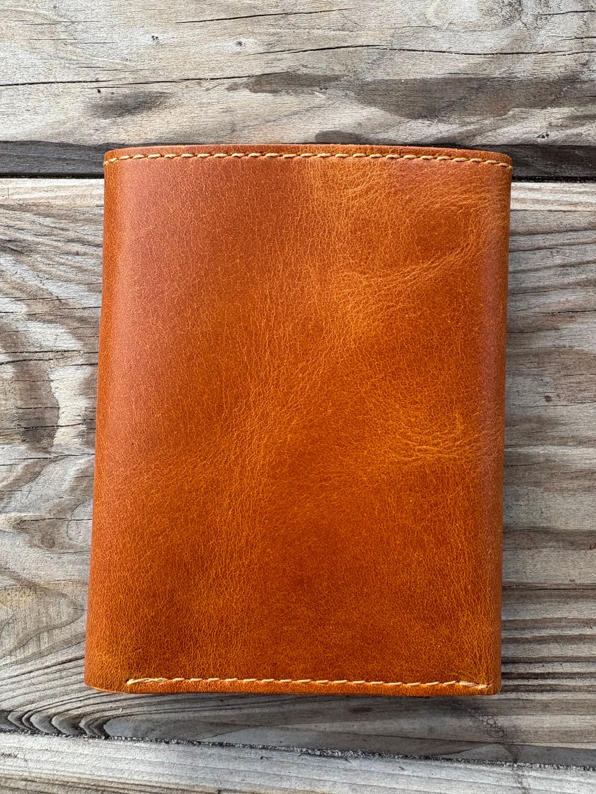 Photo by MuttBarker on October 4, 2025 of the Rodos Leather Crafts Camel Full Grain Leather Trifold Wallet in Tochigi Oil Vachetta #1 Light Brown.