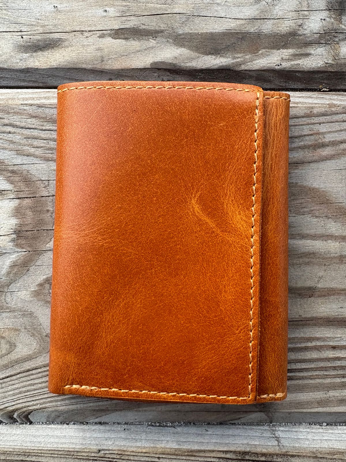 Photo by MuttBarker on October 4, 2025 of the Rodos Leather Crafts Camel Full Grain Leather Trifold Wallet in Tochigi Oil Vachetta #1 Light Brown.