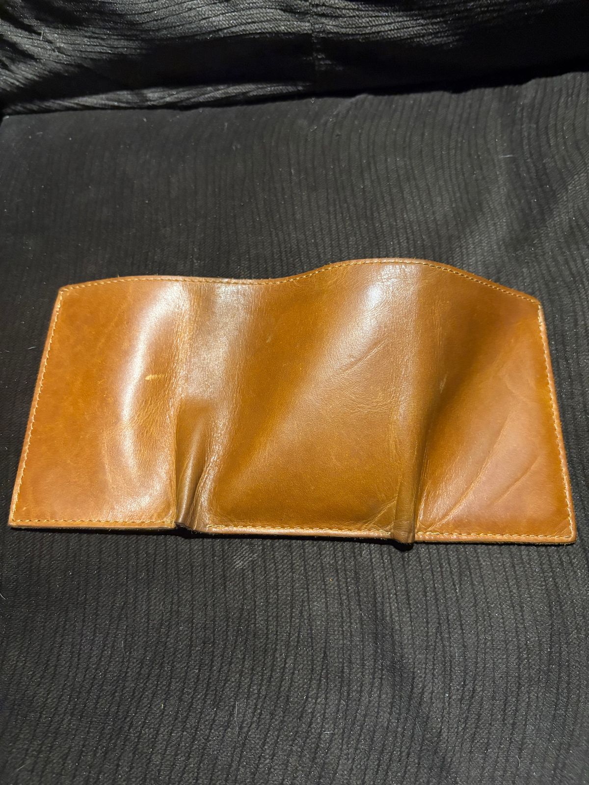 Photo by MuttBarker on December 5, 2025 of the Rodos Leather Crafts Camel Full Grain Leather Trifold Wallet in Tochigi Oil Vachetta #1 Light Brown.