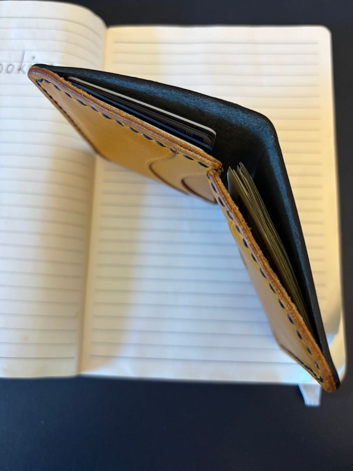 Photo by tomsbarkingdogs on November 1, 2025 of the One Star Leather Goods 6 Pocket Horizontal Learher Wallet in Horween Black/Yellow Buttero.