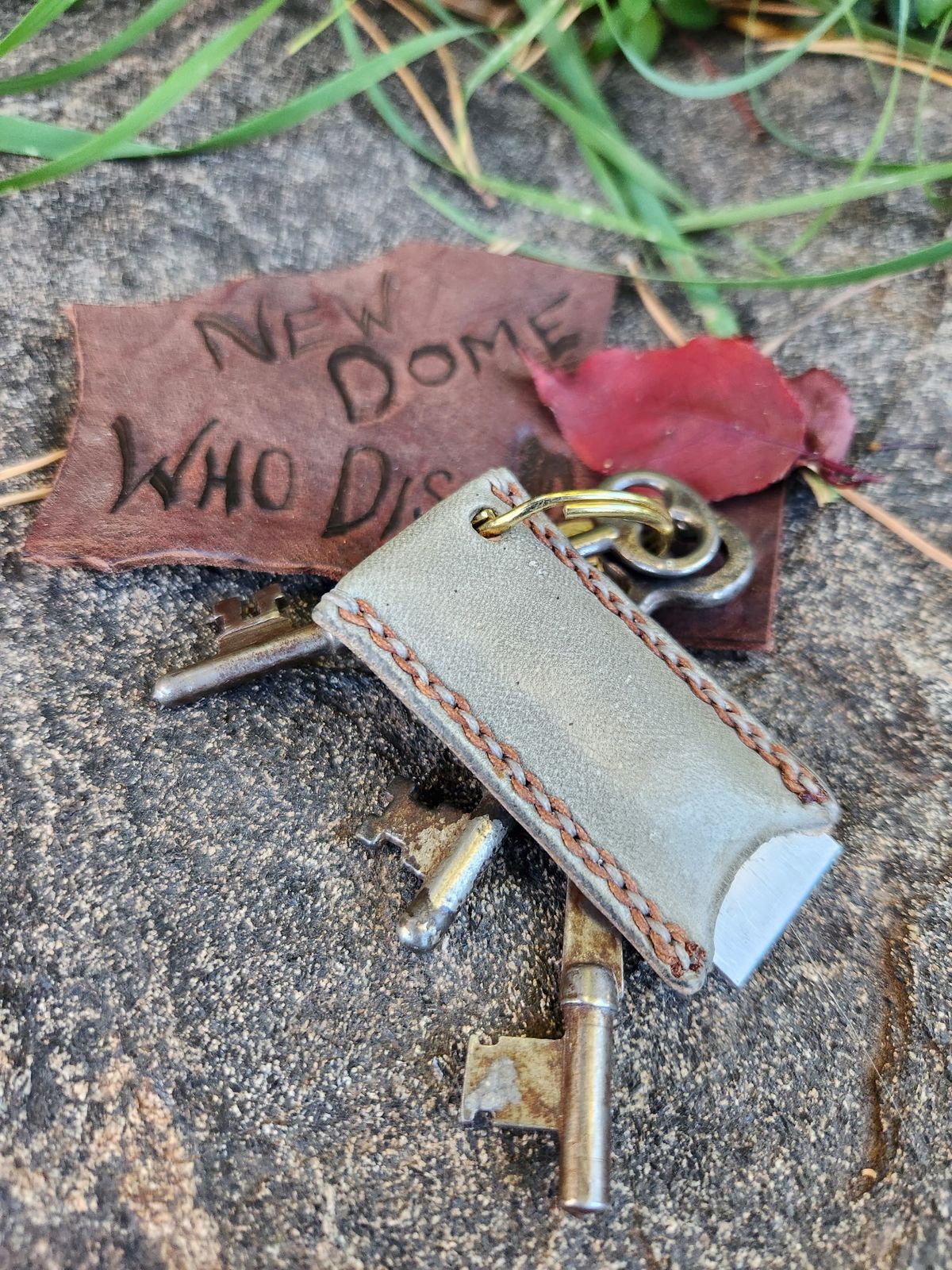 Photo by spyder550 on October 5, 2025 of the Self-Made Keychain/Bottle Opener in Wickett & Craig Grey Traditional Harness.