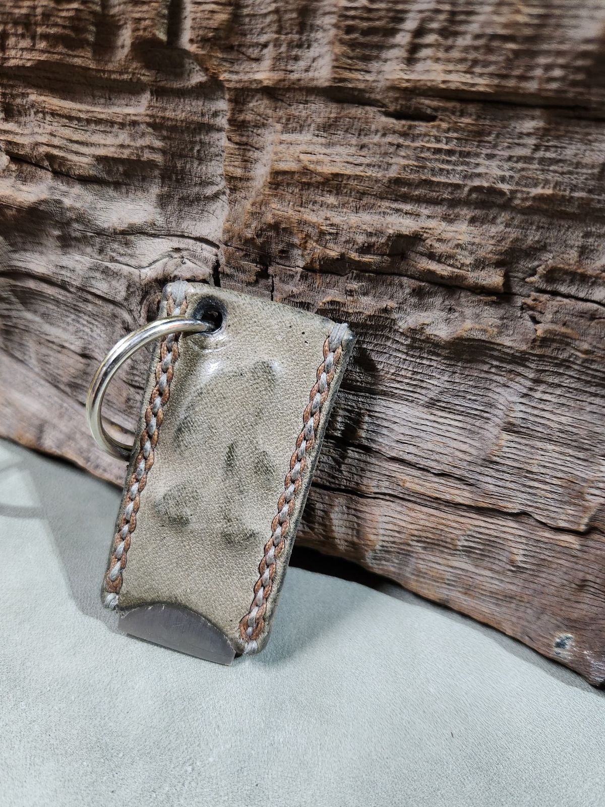 Photo by spyder550 on December 6, 2025 of the Self-Made Keychain/Bottle Opener in Wickett & Craig Grey Traditional Harness.