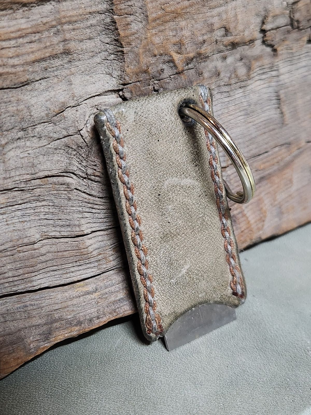 Photo by spyder550 on December 6, 2025 of the Self-Made Keychain/Bottle Opener in Wickett & Craig Grey Traditional Harness.