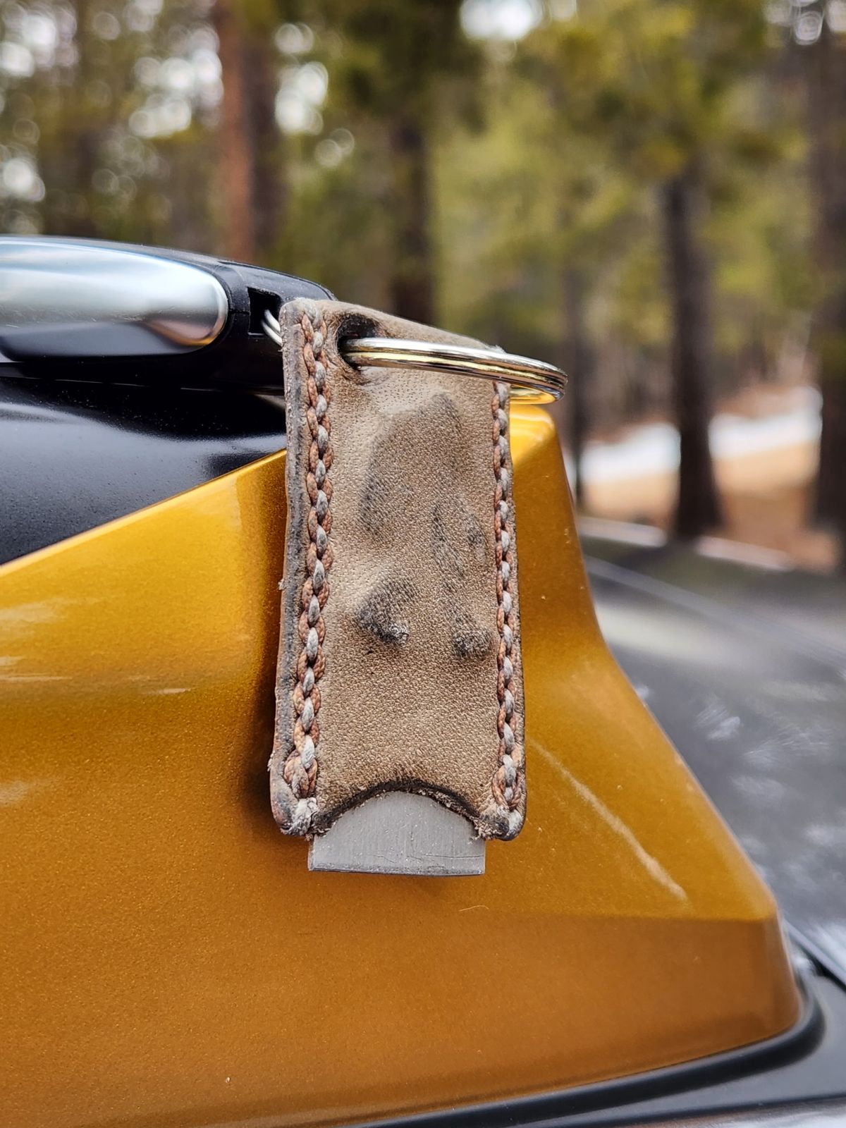 Photo by spyder550 on January 4, 2026 of the Self-Made Keychain/Bottle Opener in Wickett & Craig Grey Traditional Harness.