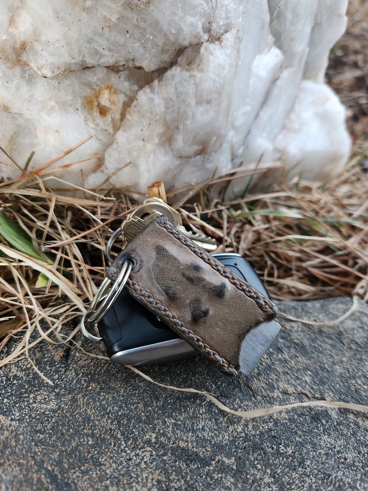 Photo by spyder550 on March 5, 2026 of the Self-Made Keychain/Bottle Opener in Wickett & Craig Grey Traditional Harness.