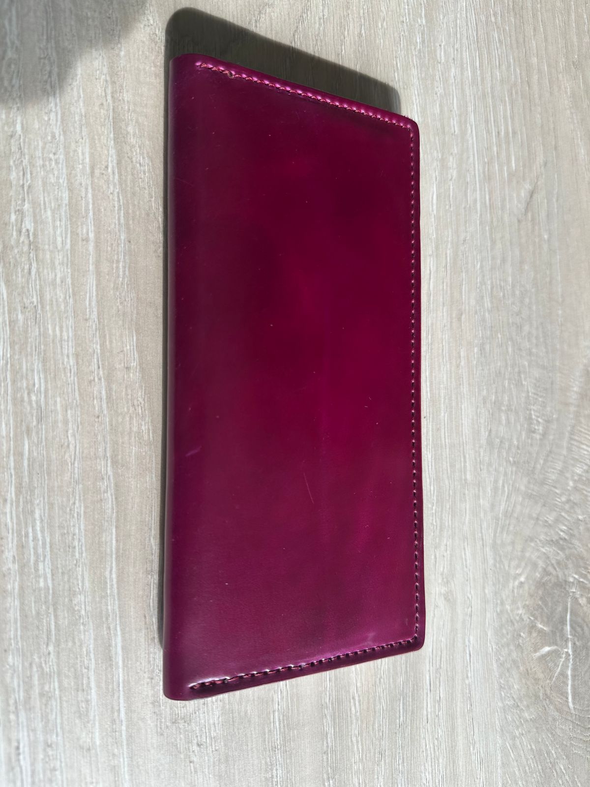 Photo by Huntsman on December 5, 2025 of the Ashland Leather Long Wallet in Horween Ultraviolet Shell Cordovan.