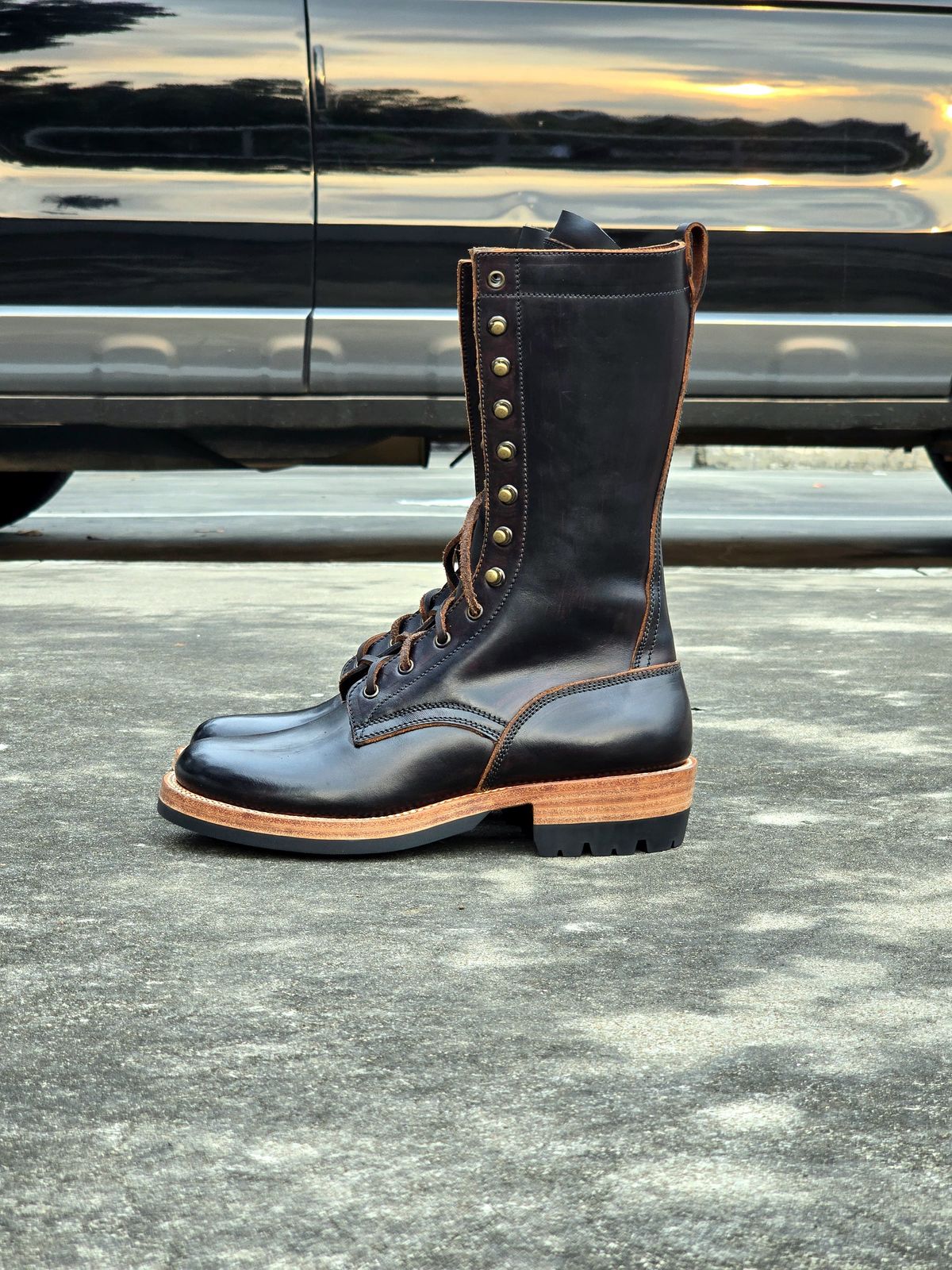 Photo by julio_archieve on October 5, 2025 of the Fortis Boots Logger Boots in Indonesian Red Brown Pull Up Overdyed Black.