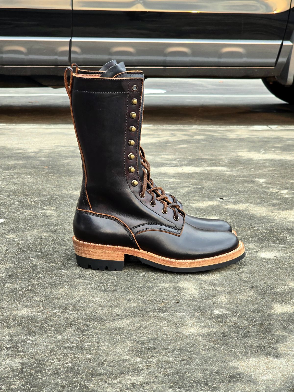 Photo by julio_archieve on October 5, 2025 of the Fortis Boots Logger Boots in Indonesian Red Brown Pull Up Overdyed Black.