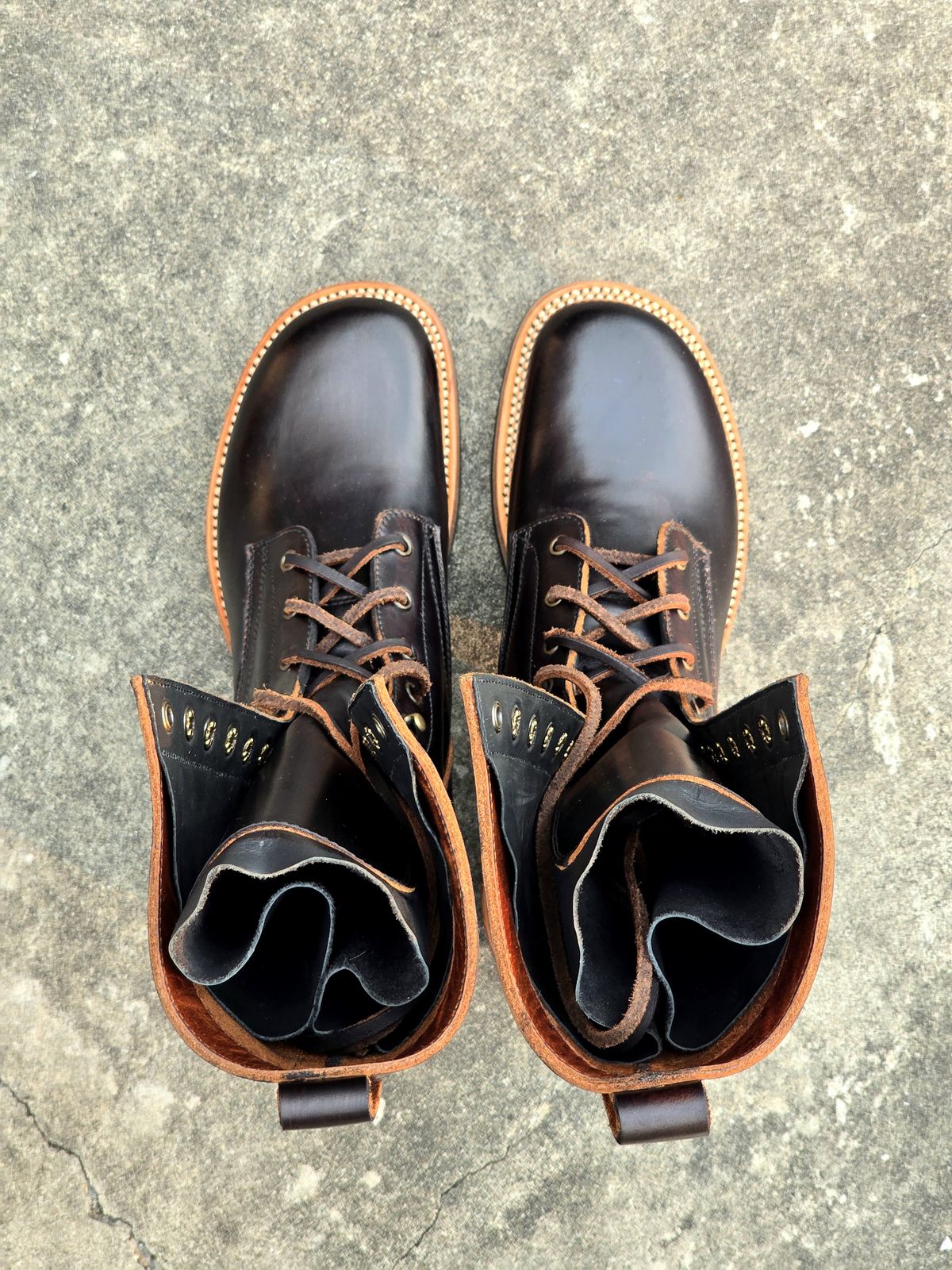 Photo by julio_archieve on October 5, 2025 of the Fortis Boots Logger Boots in Indonesian Red Brown Pull Up Overdyed Black.