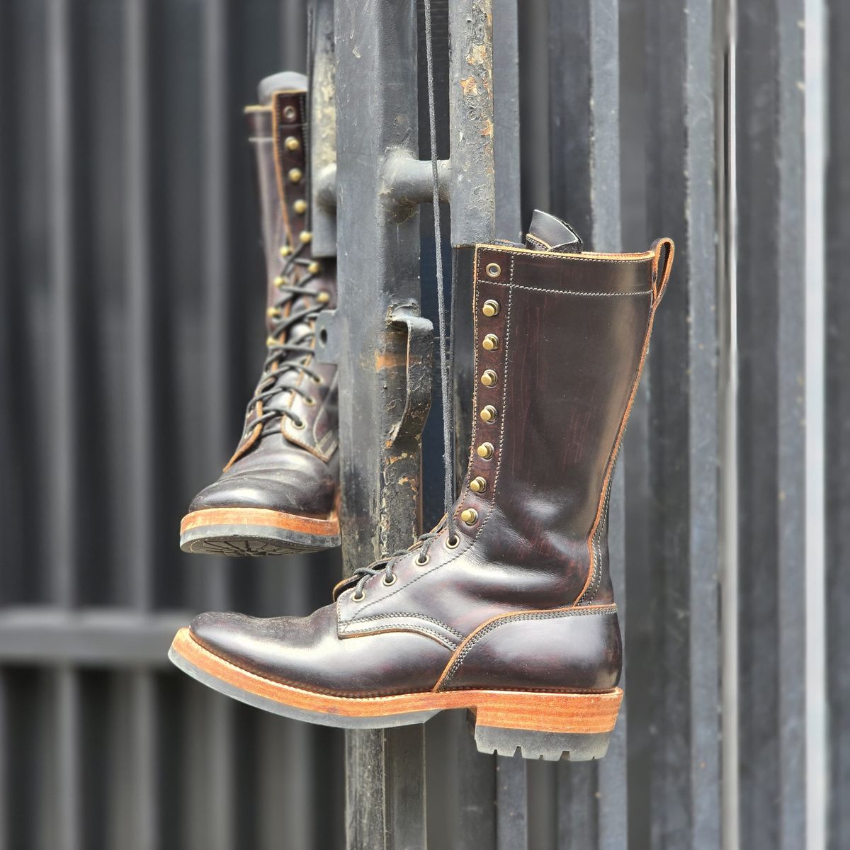 Photo by julio_archieve on November 5, 2025 of the Fortis Boots Logger Boots in Indonesian Red Brown Pull Up Overdyed Black.