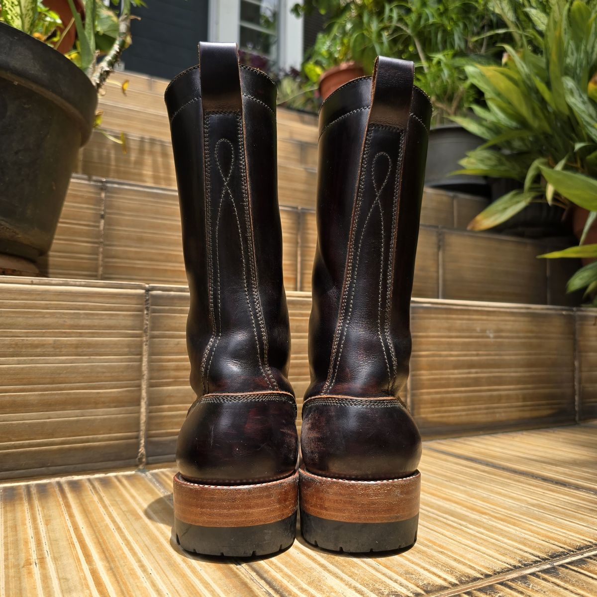 Photo by julio_archieve on November 5, 2025 of the Fortis Boots Logger Boots in Indonesian Red Brown Pull Up Overdyed Black.