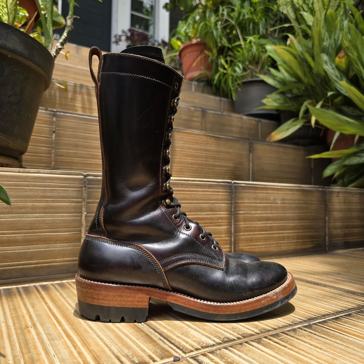 Photo by julio_archieve on November 5, 2025 of the Fortis Boots Logger Boots in Indonesian Red Brown Pull Up Overdyed Black.