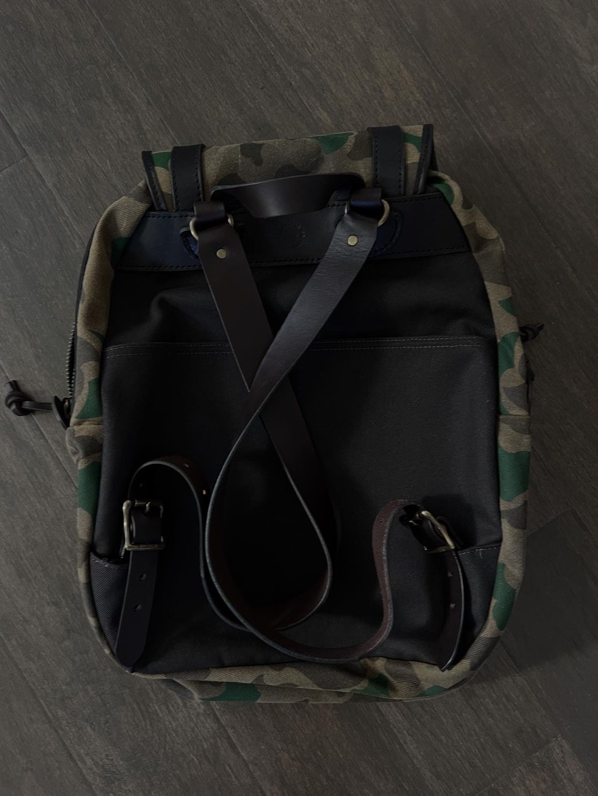 Photo by Texas_denim88 on October 29, 2025 of the Filson Large Rugged Twill Rucksack Shrub Camo in Saddle-grade Vegetable Bridle Leather & Heavily Waxed Rugged Twill.