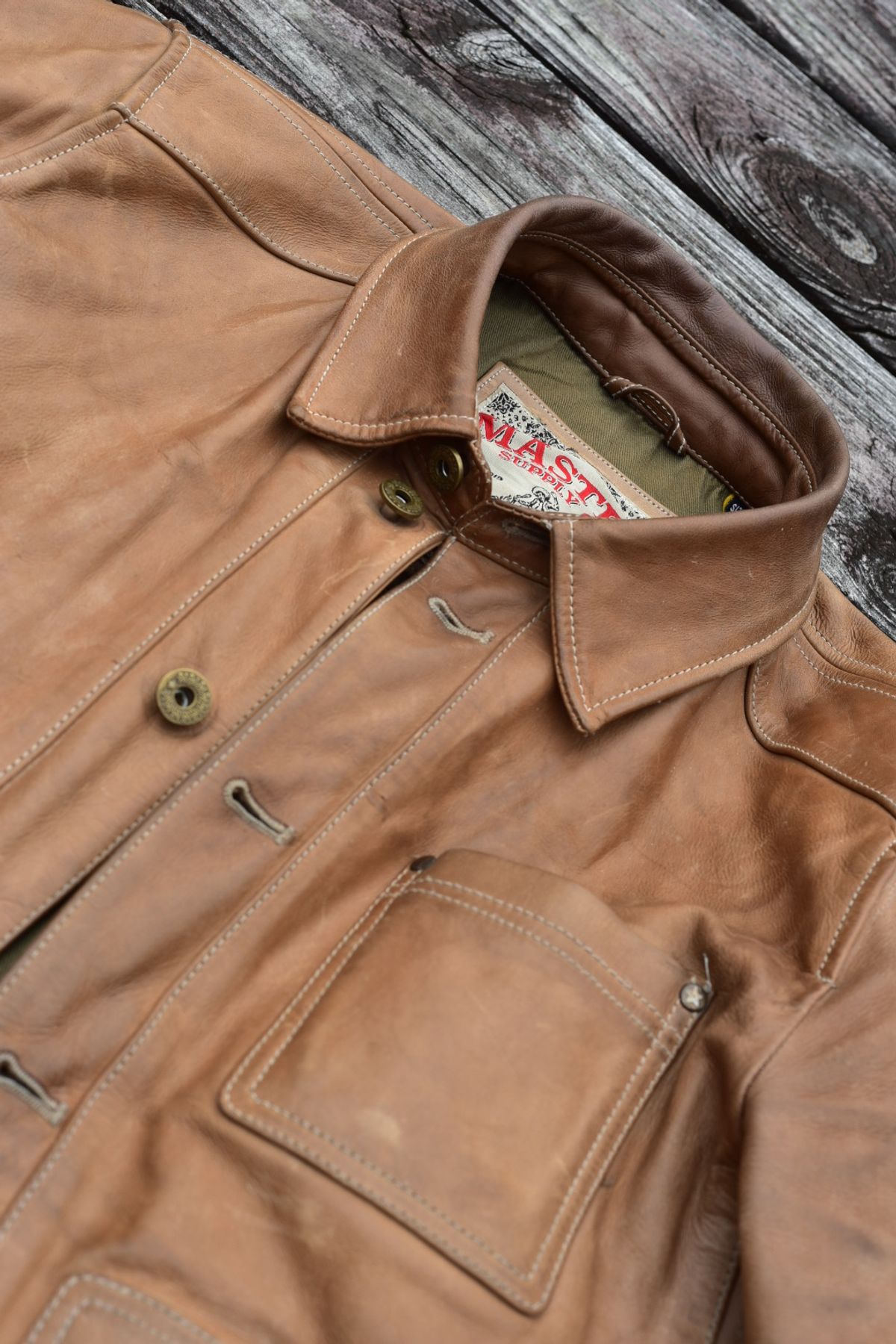 Photo by denimwatchesboots on January 2, 2026 of the Master Supply Co Field Jacket in Veg-Tanned Natural Cowhide.