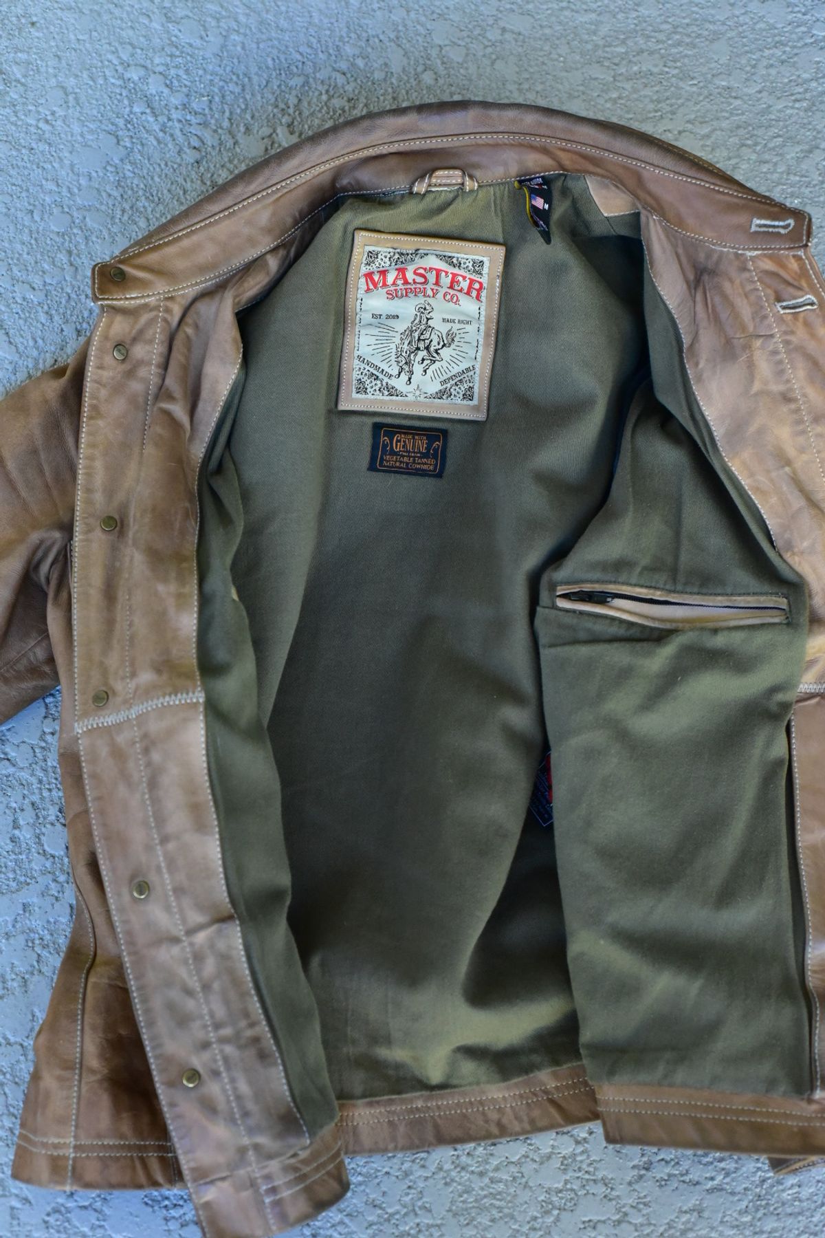 Photo by denimwatchesboots on February 4, 2026 of the Master Supply Co Field Jacket in Veg-Tanned Natural Cowhide.