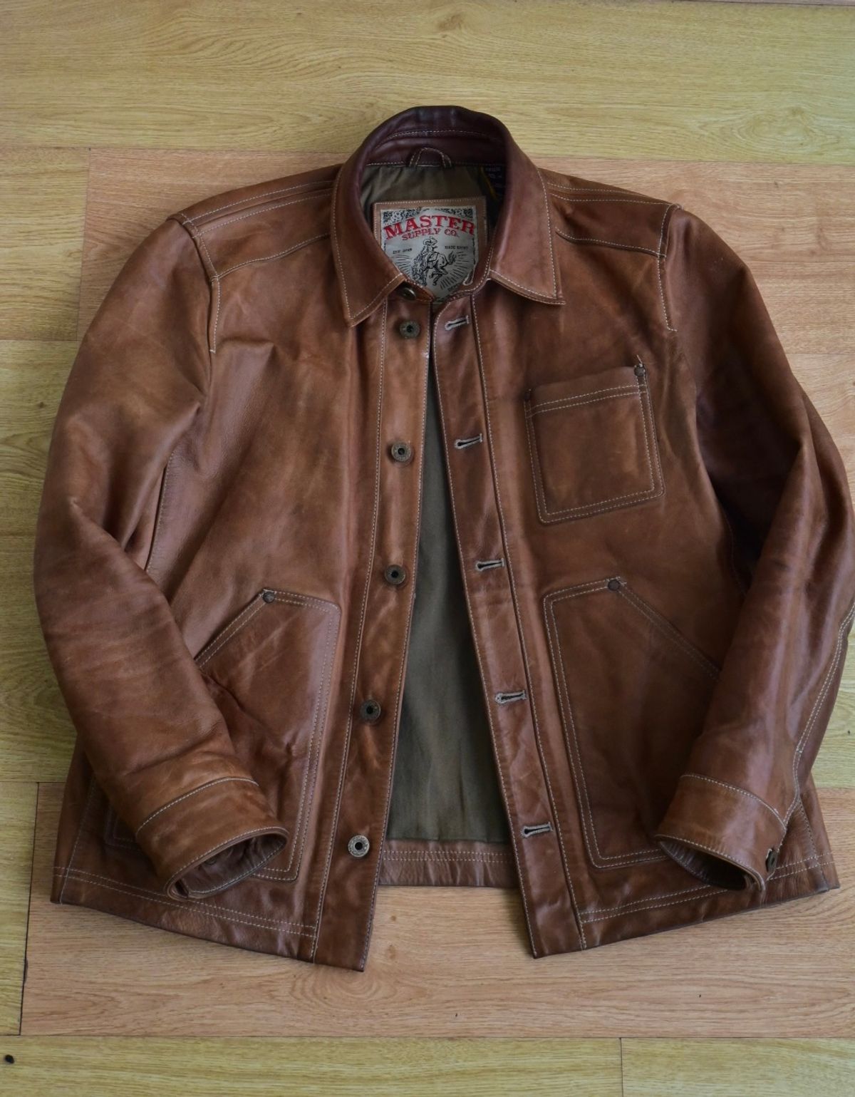 Photo by denimwatchesboots on March 5, 2026 of the Master Supply Co Field Jacket in Veg-Tanned Natural Cowhide.