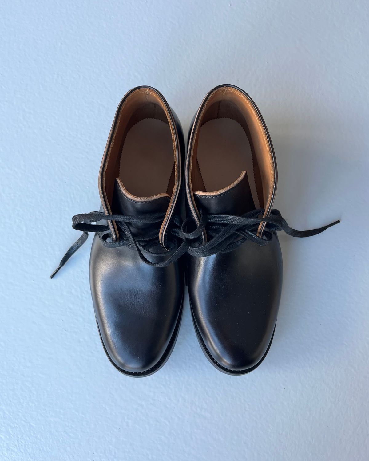 Photo by Sips on October 2, 2024 of the Flame Panda Chukkas in Maryam Natural Horsebutt Overdyed Brown then Black.