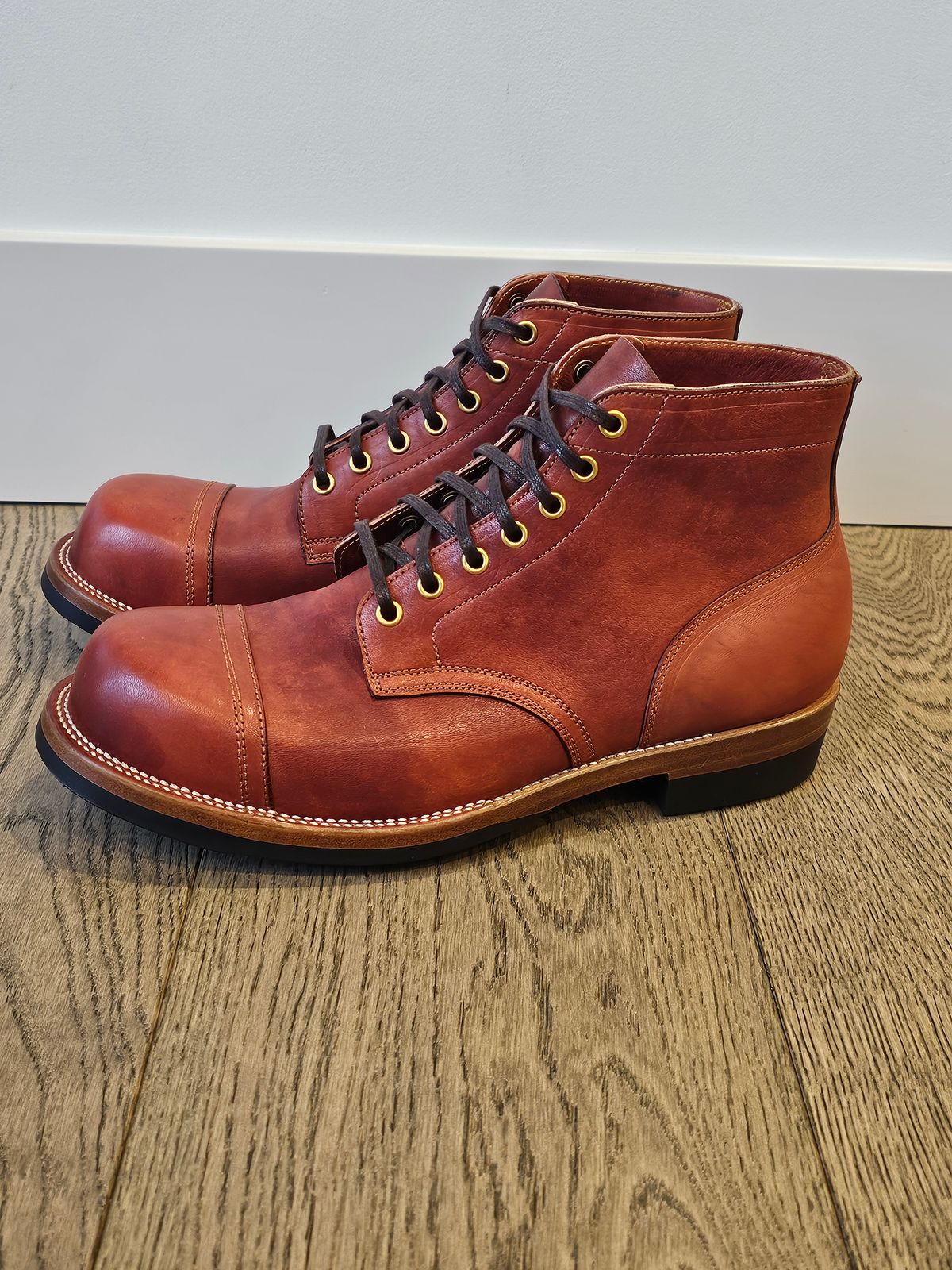 Photo by cgbaird2 on November 6, 2024 of the Iron Boots Pitman in Maryam Brick Red Hand-Dyed Horsehide.