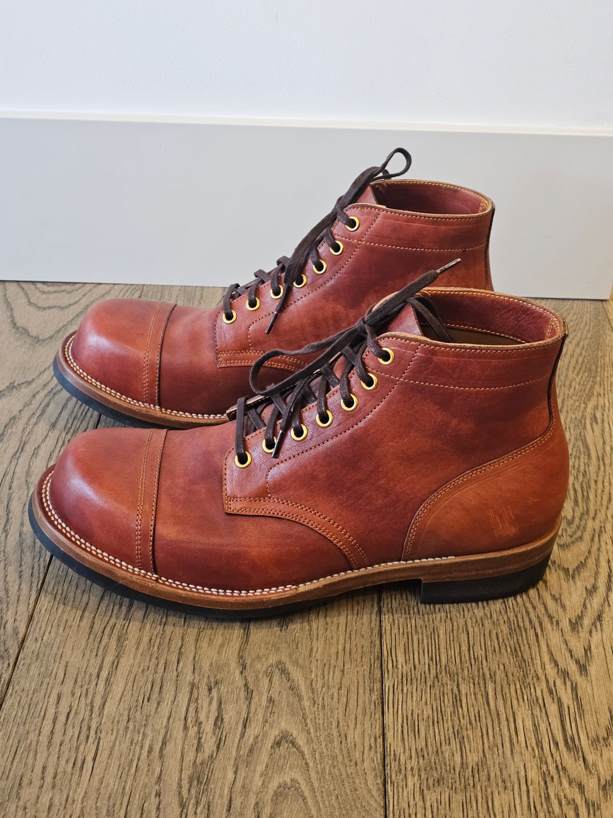 Photo by cgbaird2 on December 5, 2024 of the Iron Boots Pitman in Maryam Brick Red Hand-Dyed Horsehide.