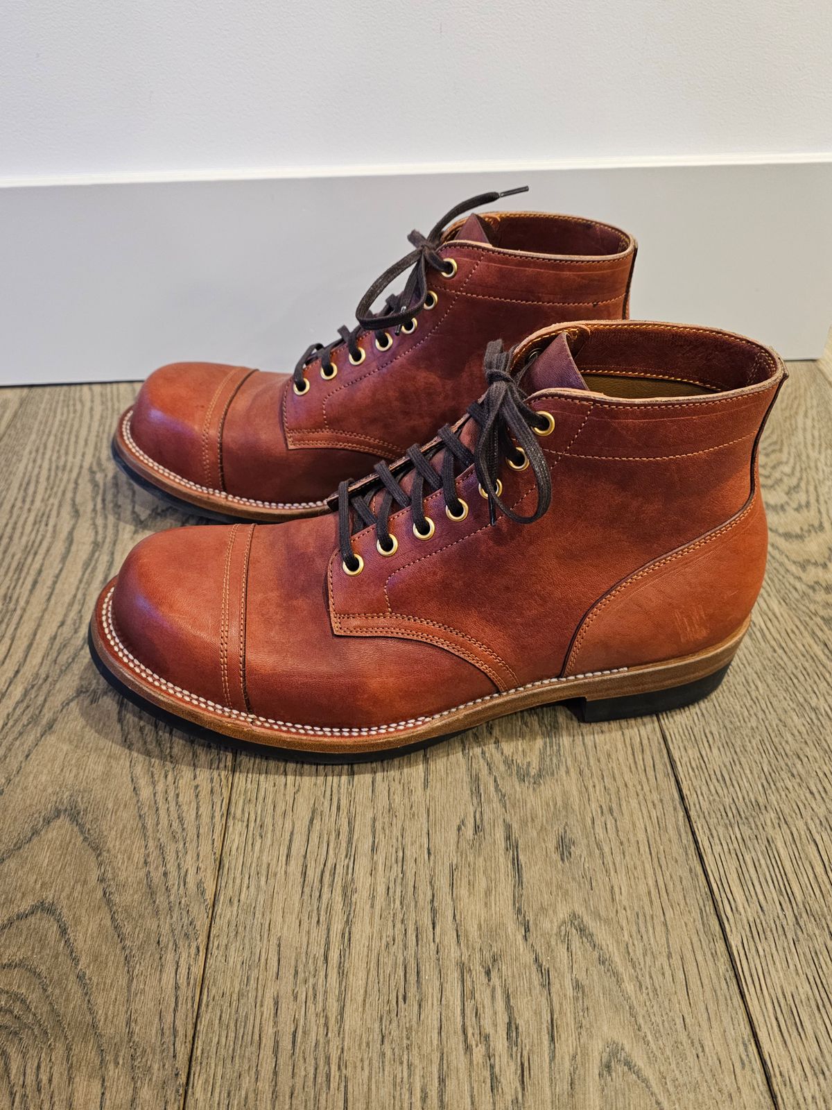 Photo by cgbaird2 on January 5, 2025 of the Iron Boots Pitman in Maryam Brick Red Hand-Dyed Horsehide.