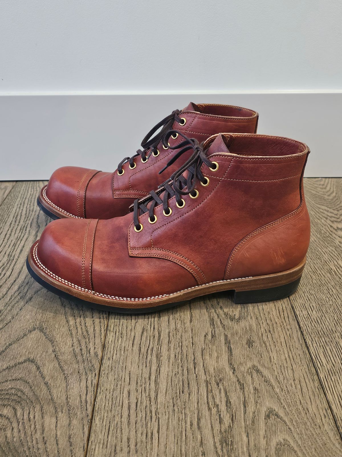 Photo by cgbaird2 on February 4, 2025 of the Iron Boots Pitman in Maryam Brick Red Hand-Dyed Horsehide.