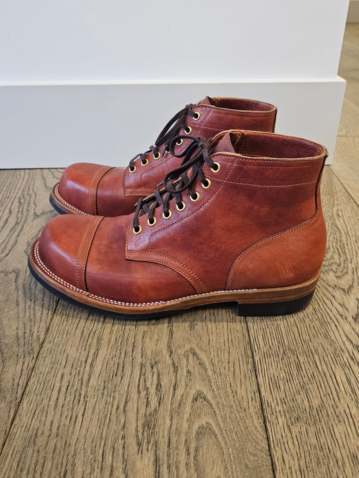 Photo by cgbaird2 on March 4, 2025 of the Iron Boots Pitman in Maryam Brick Red Hand-Dyed Horsehide.