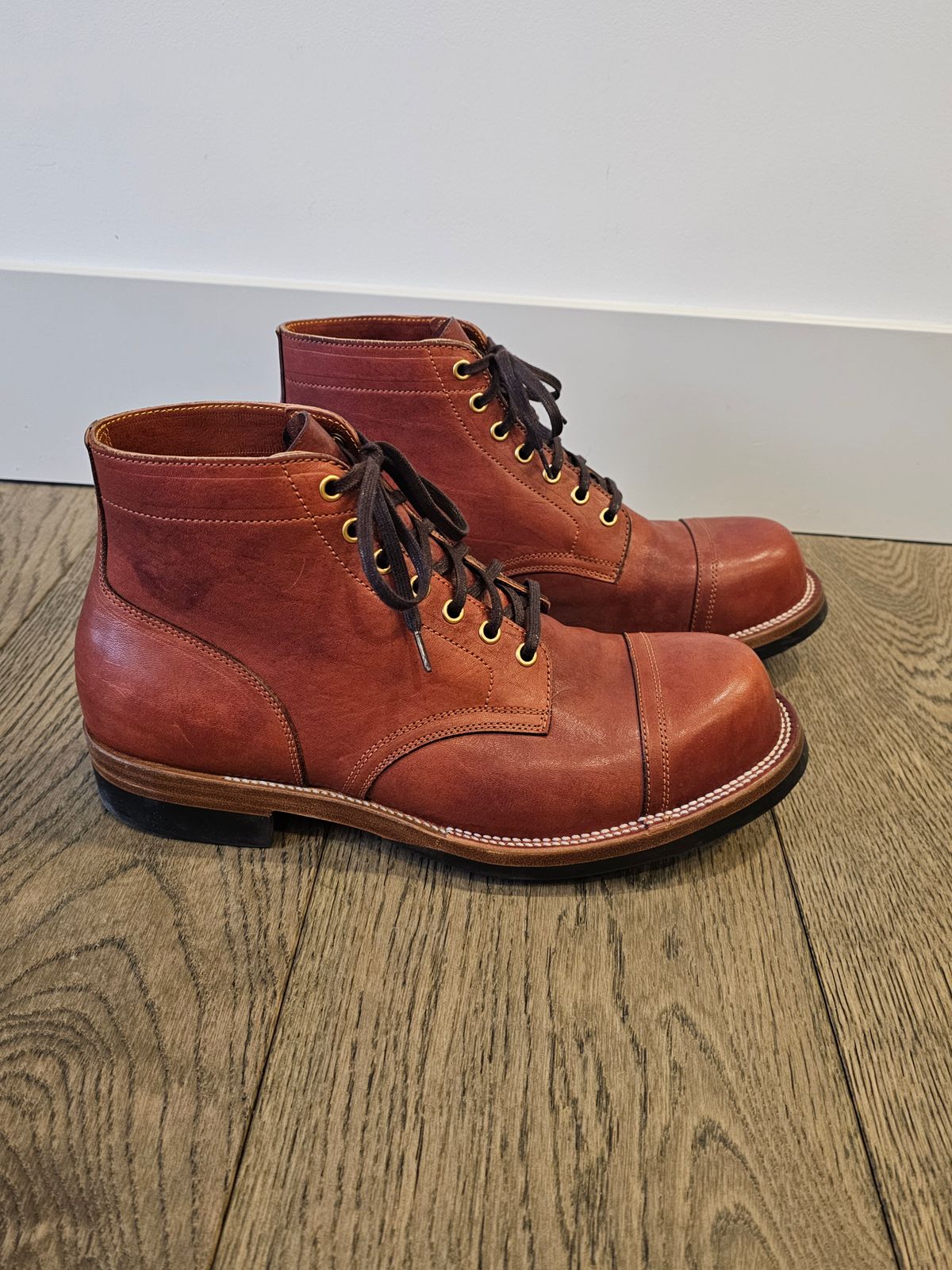 Photo by cgbaird2 on March 4, 2025 of the Iron Boots Pitman in Maryam Brick Red Hand-Dyed Horsehide.