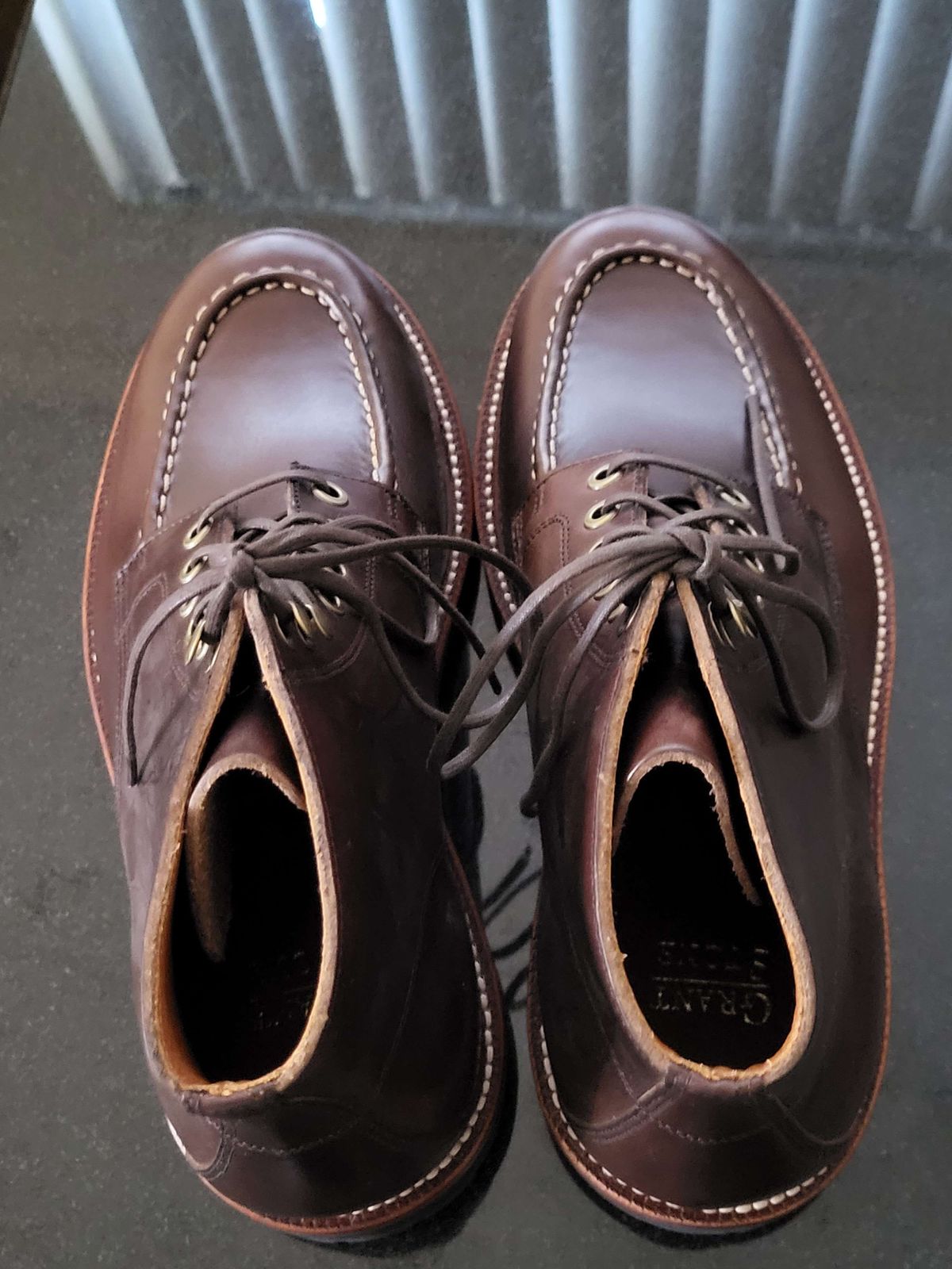 Photo by Mysterium on November 5, 2023 of the Grant Stone Brass Boot in Horween Crimson Chromexcel.