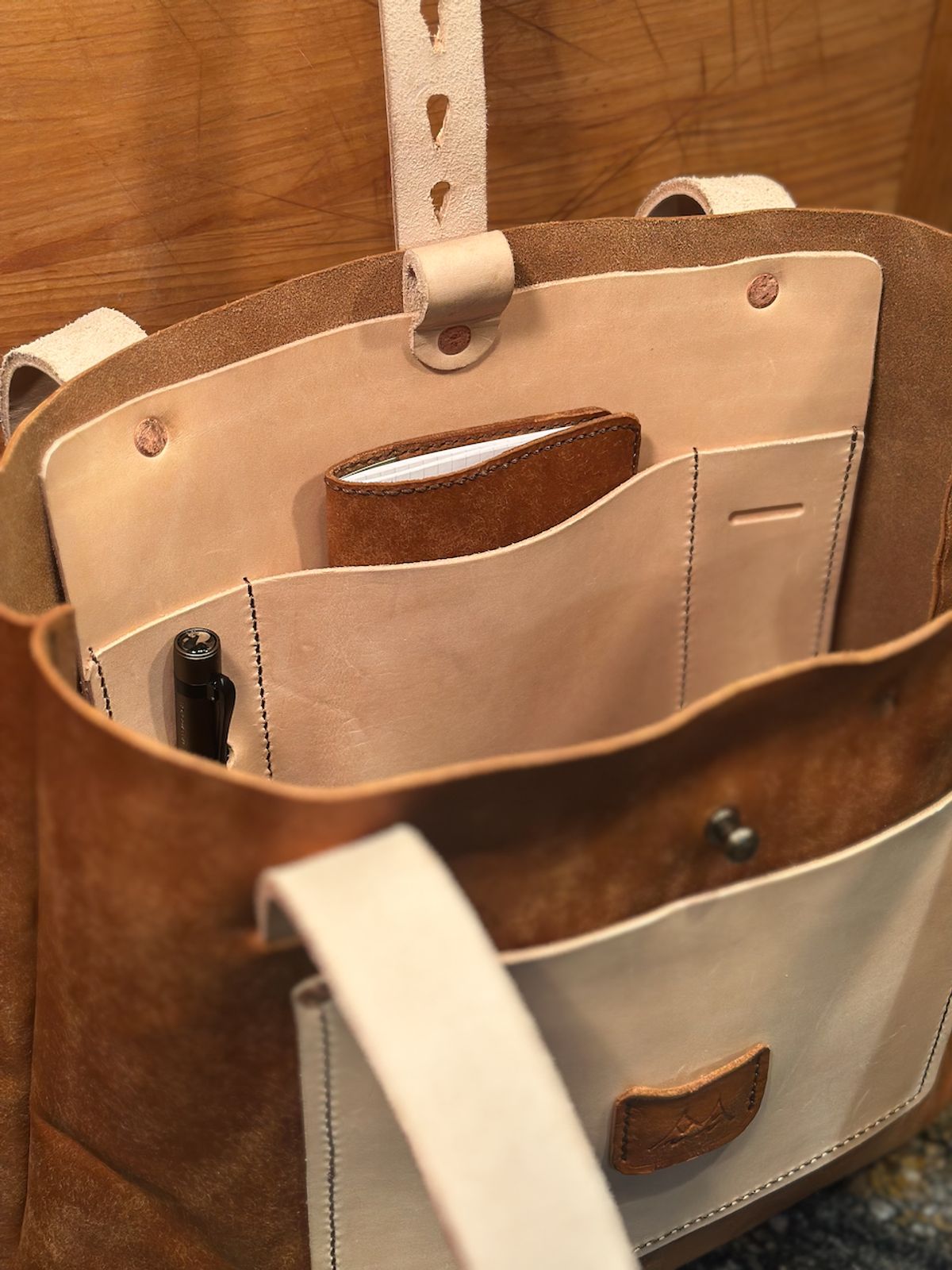 Photo by cows_electronico on October 6, 2025 of the Swampoodle Homemade Goods Tote Bag and Field Notes Cover Combo in Conceria Walpier Natural Mud Rustic Vachetta & Supernatural Natural Veg Tan.