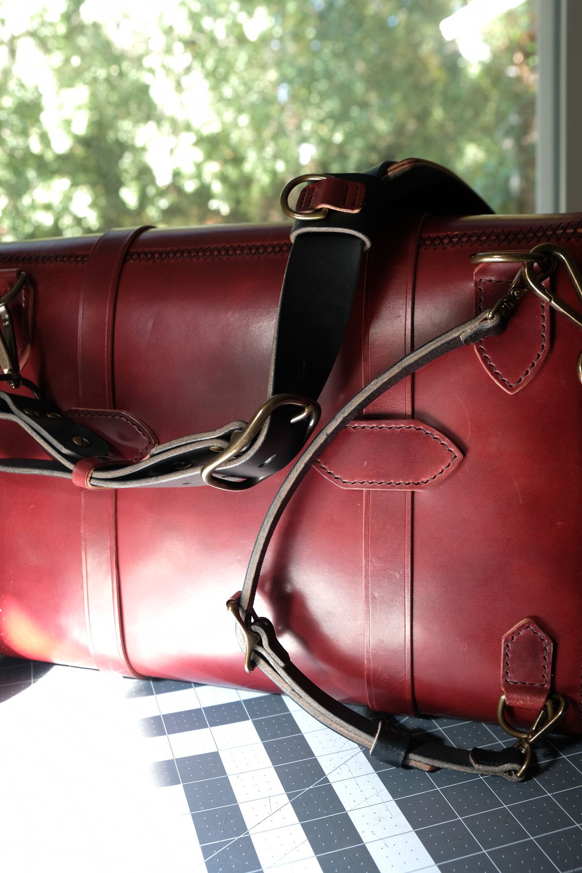 Photo by morosoleatherworks on November 5, 2025 of the Moroso Leatherworks Messenger Bag in Wickett & Craig Burgundy Burnt Harness & Wickett & Craig Black Milled Traditional Harness.