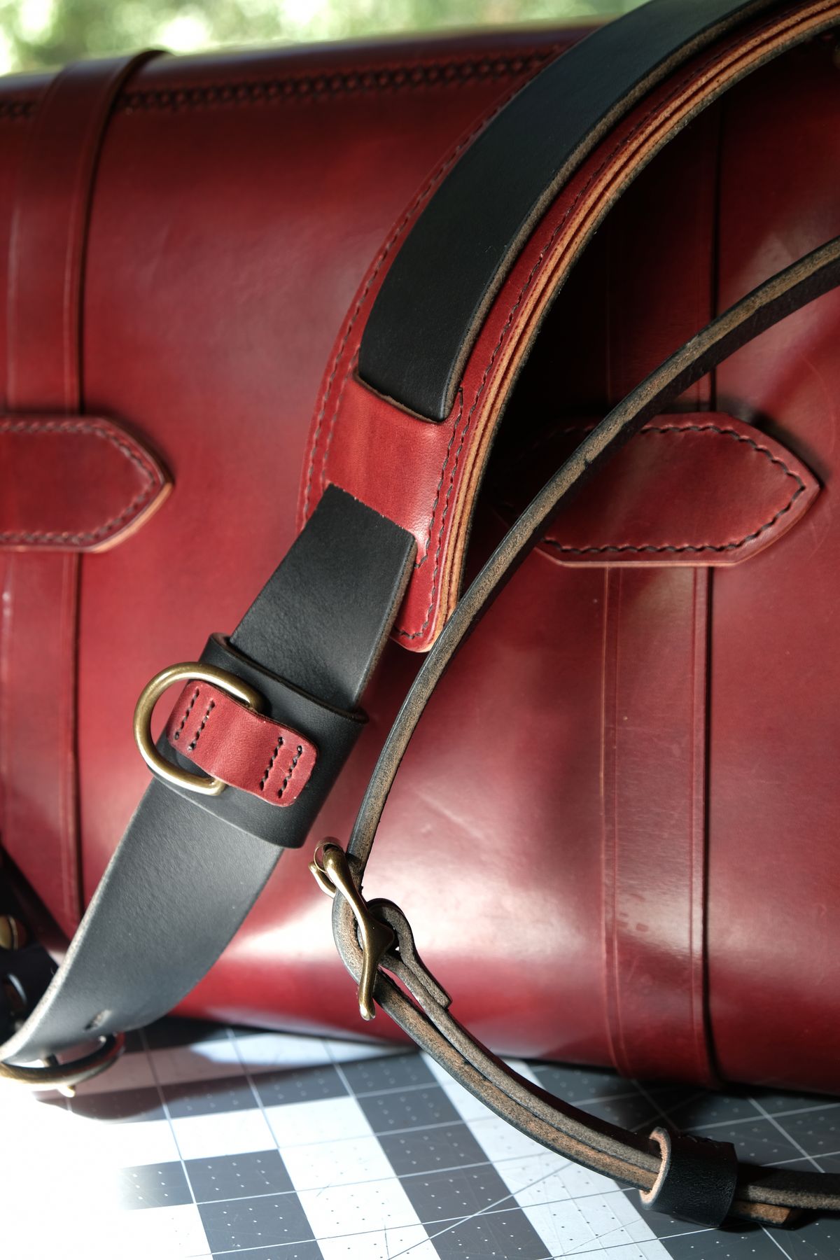 Photo by morosoleatherworks on November 5, 2025 of the Moroso Leatherworks Messenger Bag in Wickett & Craig Burgundy Burnt Harness & Wickett & Craig Black Milled Traditional Harness.