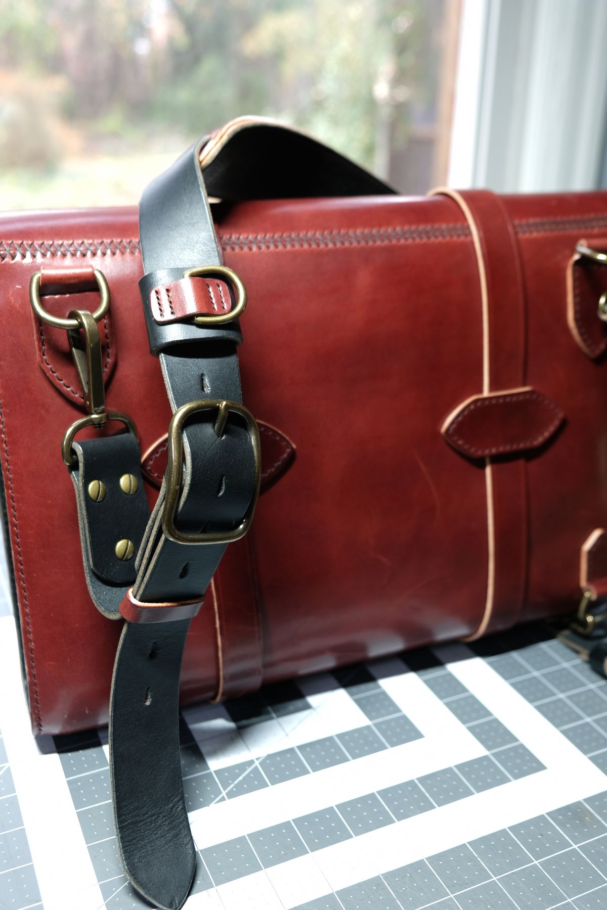 Photo by morosoleatherworks on December 5, 2025 of the Moroso Leatherworks Messenger Bag in Wickett & Craig Burgundy Burnt Harness & Wickett & Craig Black Milled Traditional Harness.