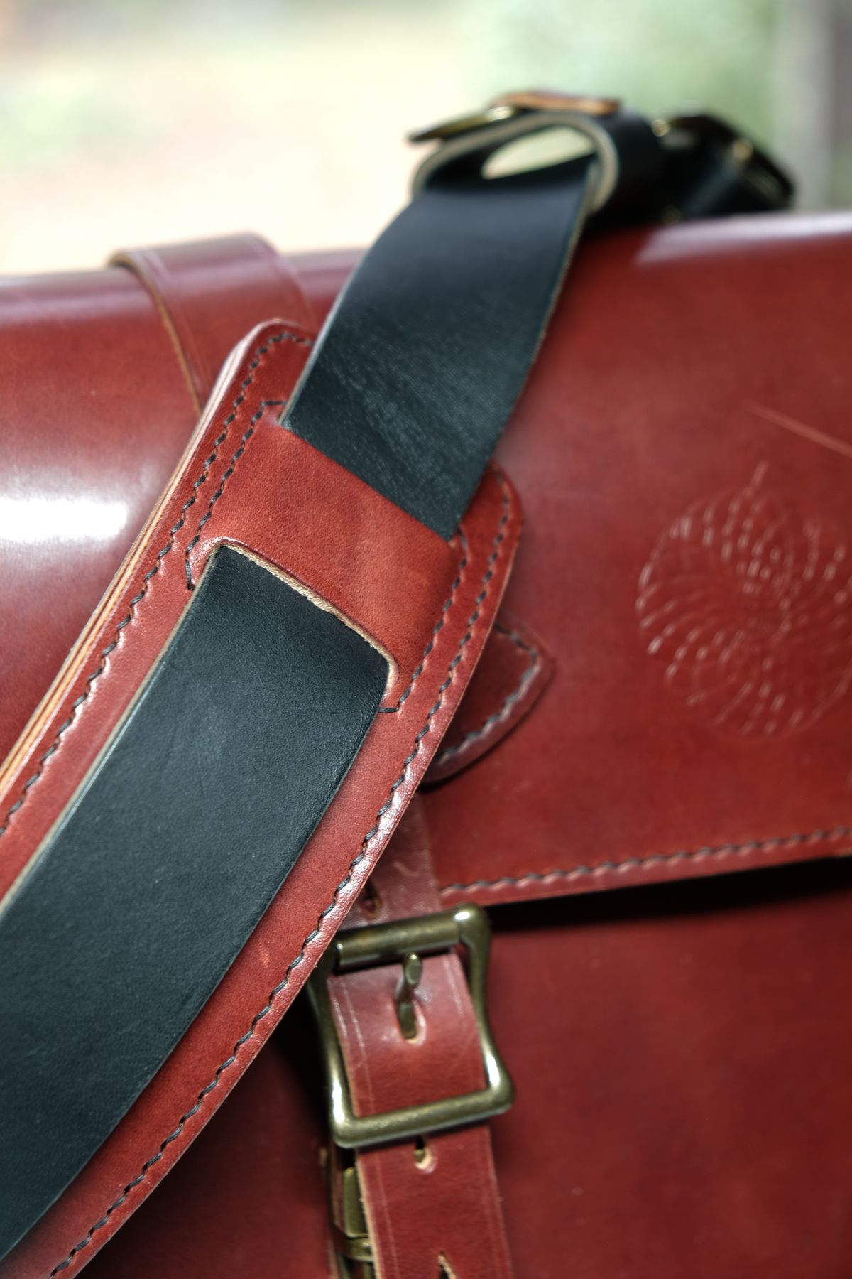Photo by morosoleatherworks on December 5, 2025 of the Moroso Leatherworks Messenger Bag in Wickett & Craig Burgundy Burnt Harness & Wickett & Craig Black Milled Traditional Harness.