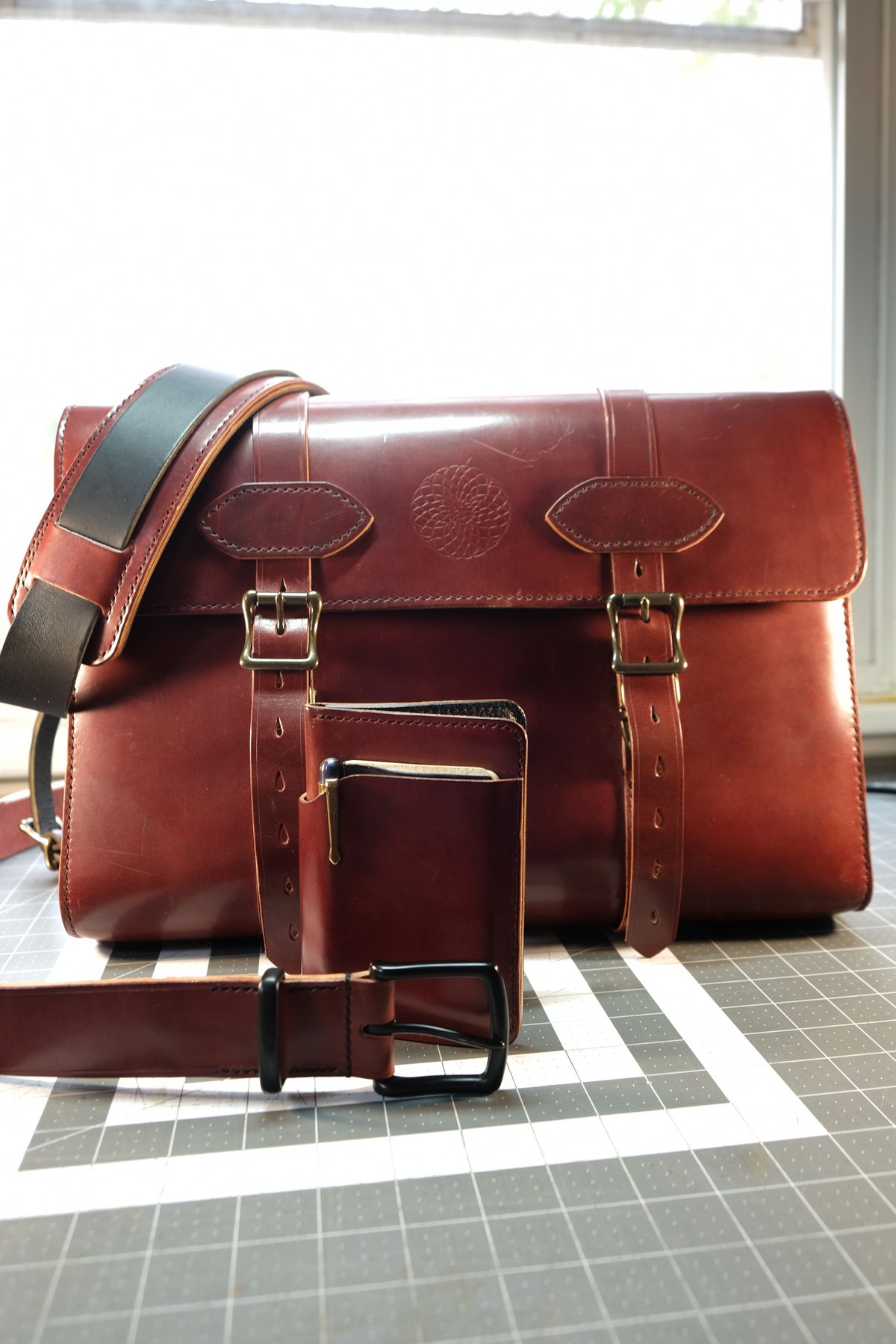 Photo by morosoleatherworks on February 5, 2026 of the Moroso Leatherworks Messenger Bag in Wickett & Craig Burgundy Burnt Harness & Wickett & Craig Black Milled Traditional Harness.