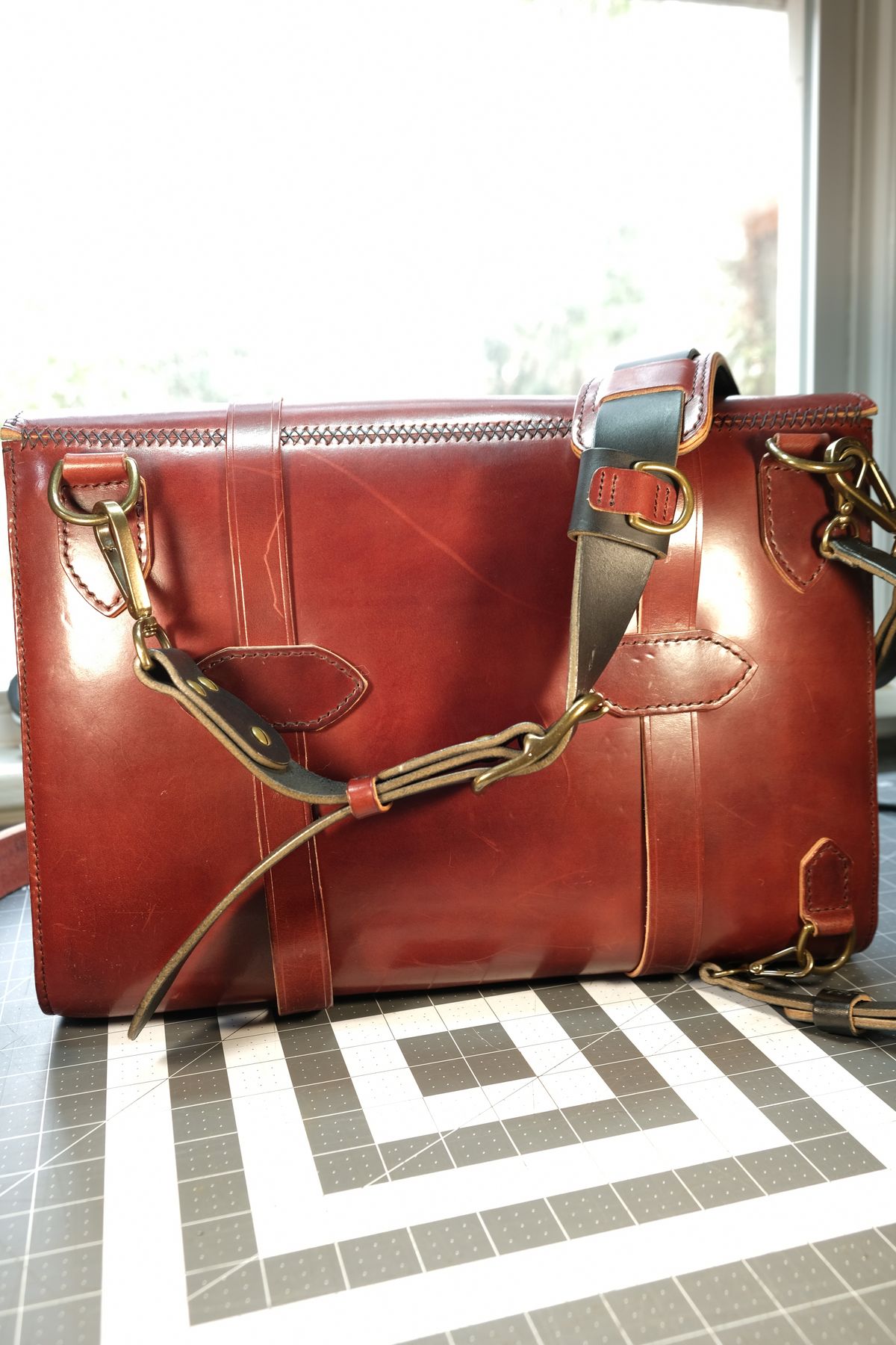 Photo by morosoleatherworks on February 5, 2026 of the Moroso Leatherworks Messenger Bag in Wickett & Craig Burgundy Burnt Harness & Wickett & Craig Black Milled Traditional Harness.