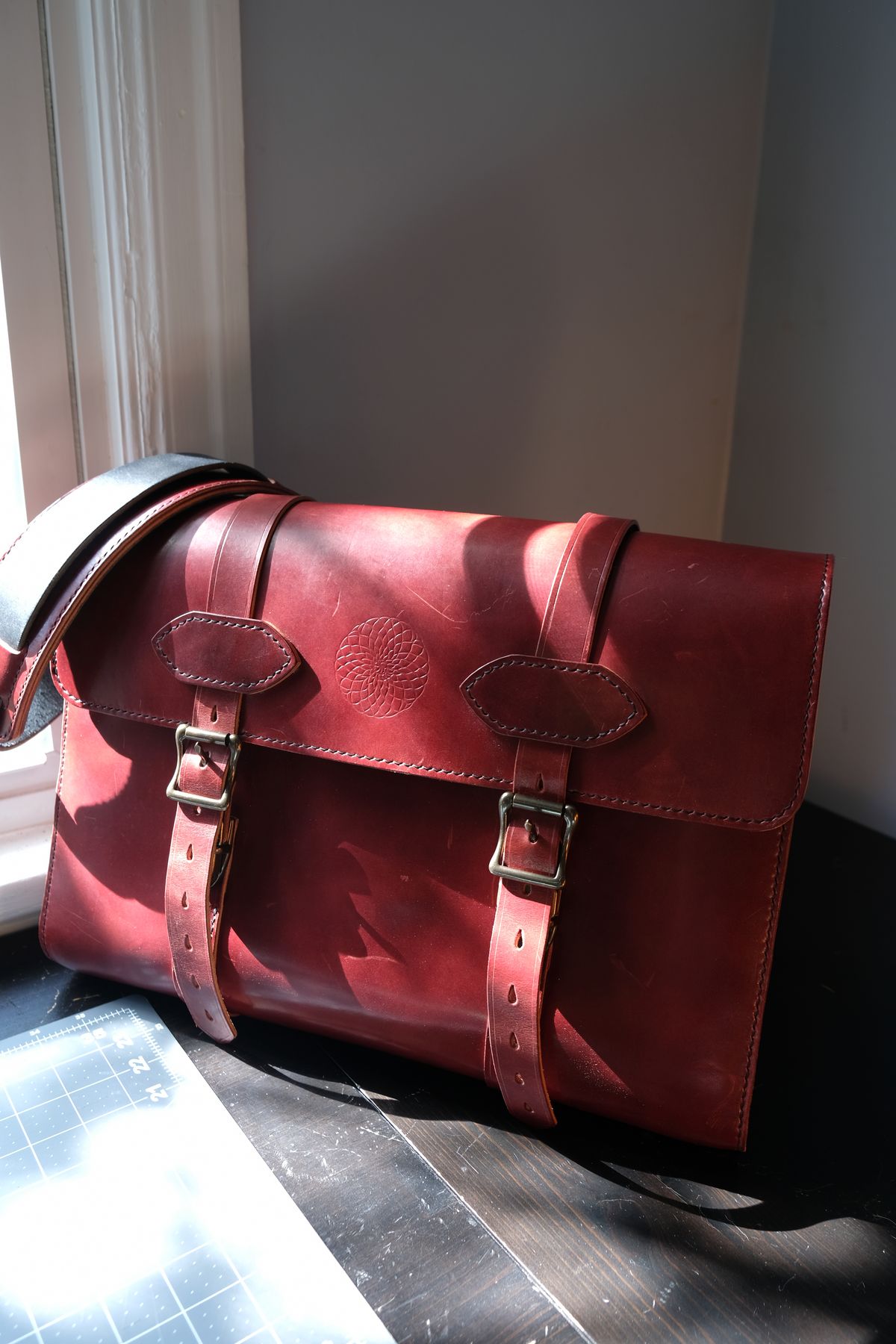 Photo by morosoleatherworks on April 4, 2026 of the Moroso Leatherworks Messenger Bag in Wickett & Craig Burgundy Burnt Harness & Wickett & Craig Black Milled Traditional Harness.