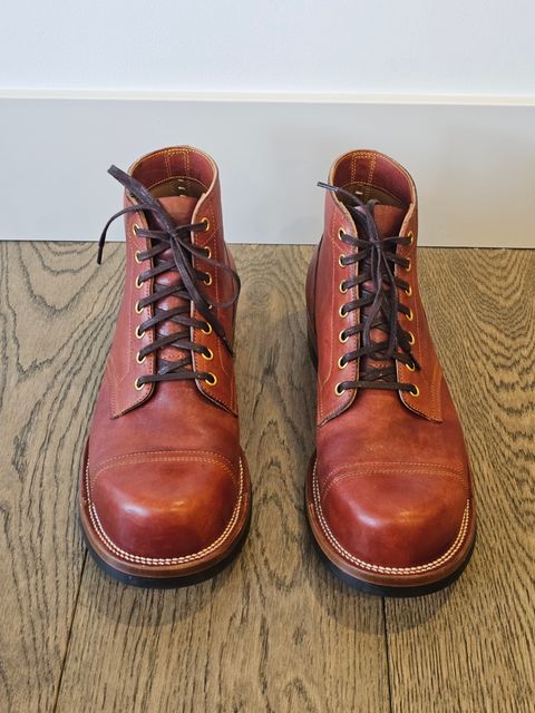 Photo by cgbaird2 on December 5, 2024 of the Iron Boots Pitman in Maryam Brick Red Hand-Dyed Horsehide.