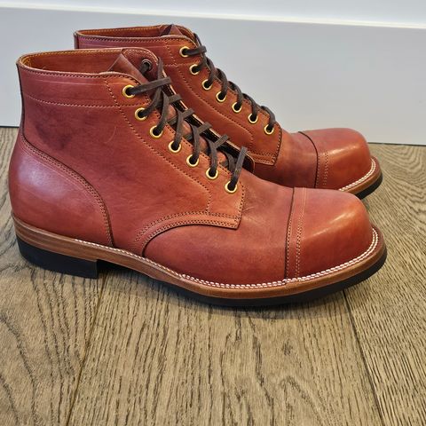 View photo of Iron Boots Pitman in Maryam Brick Red Hand-Dyed Horsehide