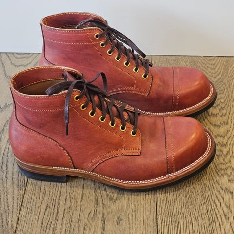 View photo of Iron Boots Pitman in Maryam Brick Red Hand-Dyed Horsehide