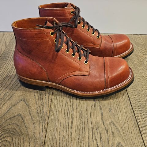 View photo of Iron Boots Pitman in Maryam Brick Red Hand-Dyed Horsehide