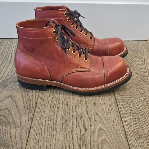 View photo of Iron Boots Pitman in Maryam Brick Red Hand-Dyed Horsehide